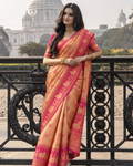 Peachy Orange Kanjivaram SIlk Saree with Intricate Circular Zari Motifs and Pink Contrast Border